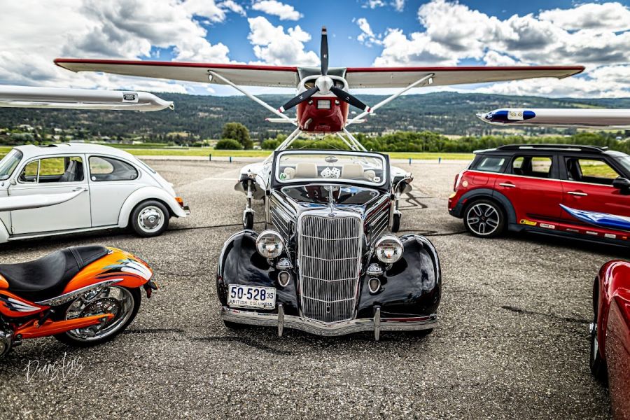 <who>Photo credit: Deans Lens</who>A vintage 1935 vehicle and Cessna 185.