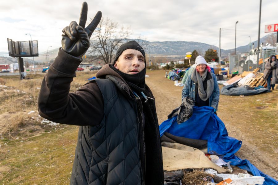 <who>Photo Credit: NowMedia/Gord Goble</who> Nevada Green, flashing the victory sign and now housed, says he was a past resident of the Fairview encampment.
