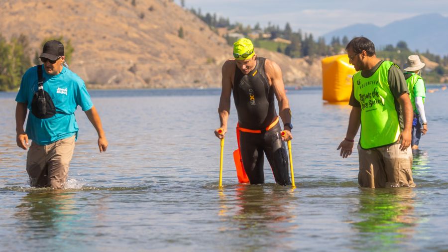 <who>Photo Credit: Gord Goble</who> Mark Herbison was given his crutches to exit the water at the finish line