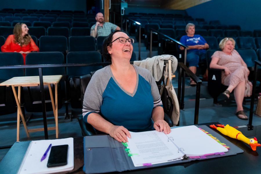 <who>Photo Credit: Many Hats/Gord Goble</who> Director Dawn Bassett (centre) enjoys the action
