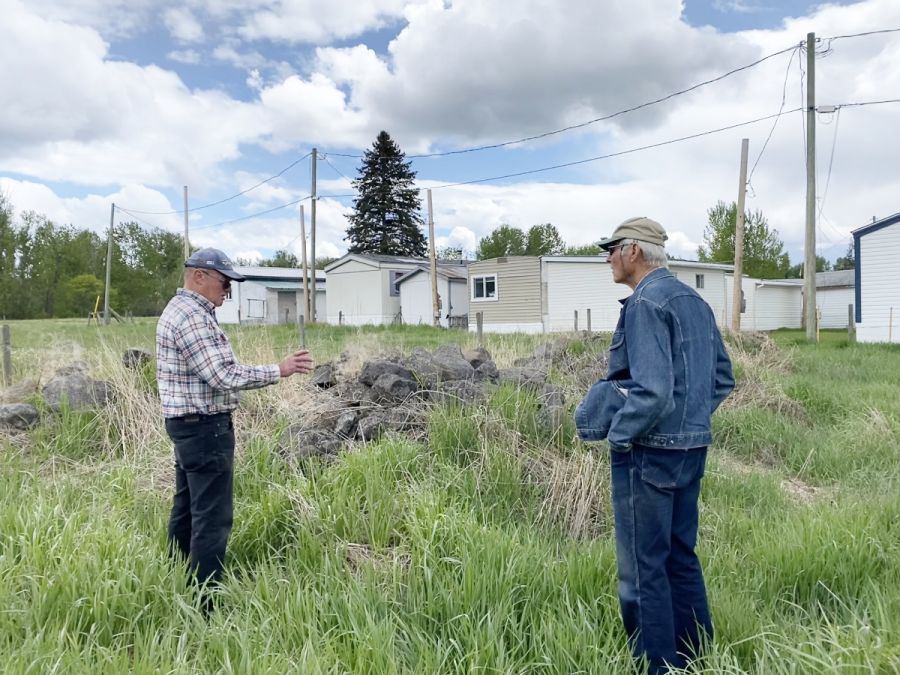 <who> Photo Credit: Andie Mollins, Local Journalism Initiative Reporter</who> Hoyrup and Atamanenko discuss how they might at least move and salvage stones from the courthouse property which were once part of a wall along the old wagon road.