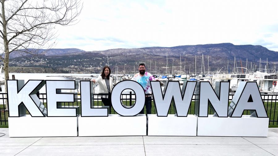 <who>Photo credit: Steve MacNaull/KelownaNow</who>Tourism Kelowna's Lisanne Ballantyne, left, and Chris Lewis show off Kelowna's new 'sense of place' mobile sign.