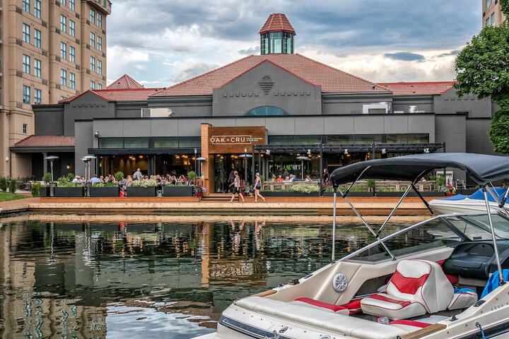 <who>Photo credit: Marriott</who>The Delta Grand's Oak+Cru restaurant has patio seating lagoon-side.