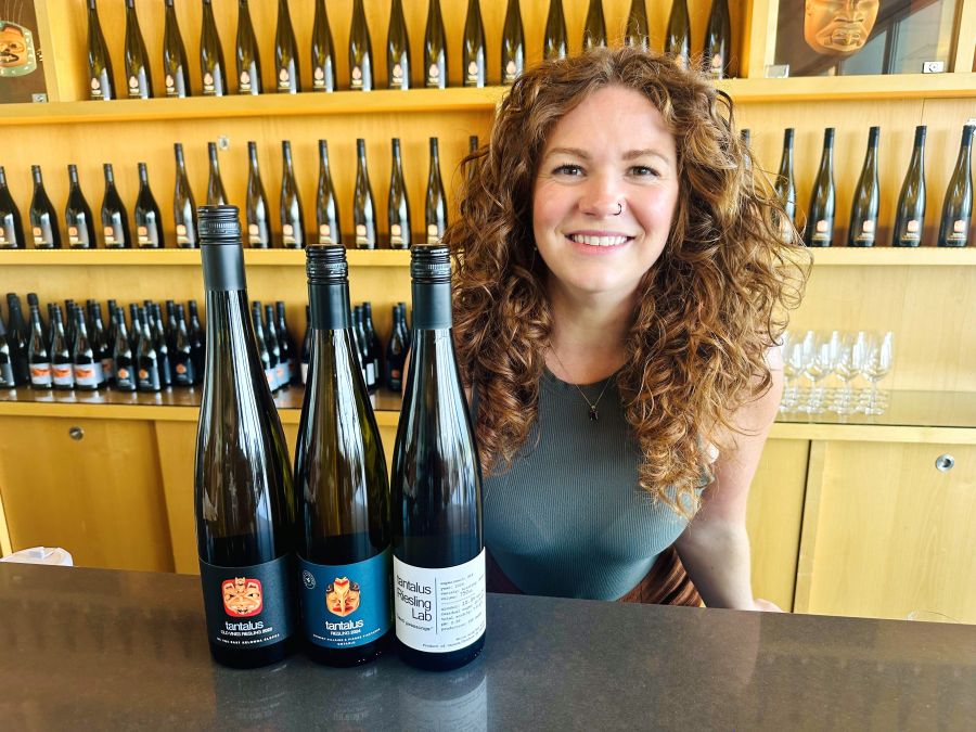 <who>Photo credits: Steve MacNaull/NowMedia Group</who>Tantalus' tasting room supervisor Alexa Burnett with the 2022 Old Vines Riesling, left, 2024 Riesling made of Ontario grapes and the 2024 Riesling Lab, also made of Ontario grapes.