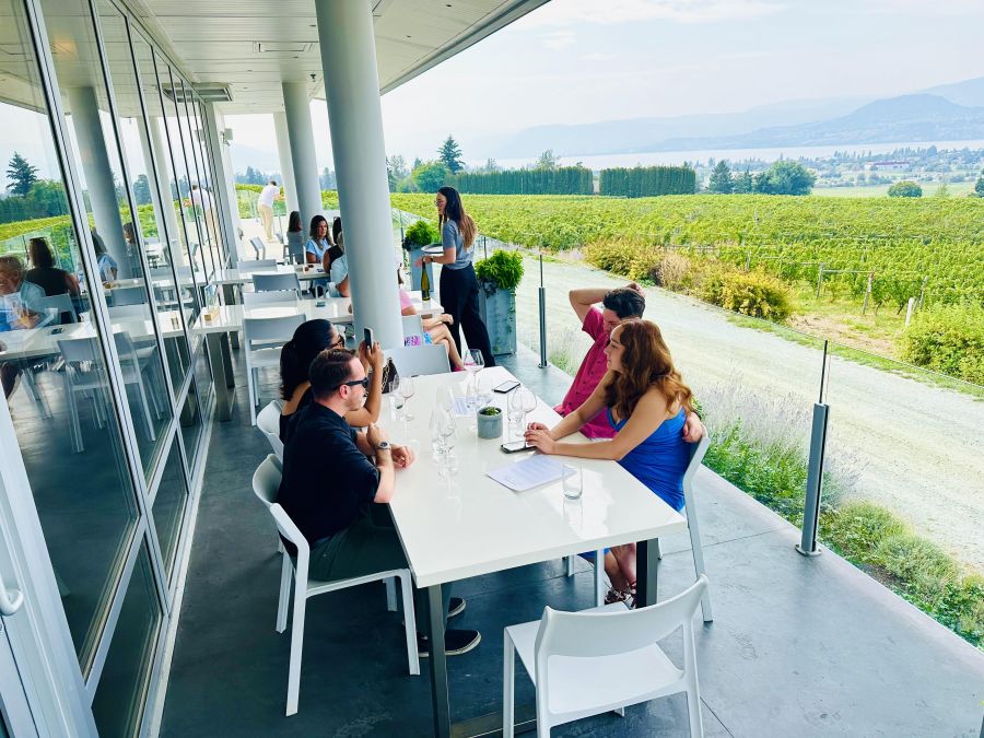 </who>The tasting patio at Tantalus has views over vineyards and the city to Okanagan Lake.
