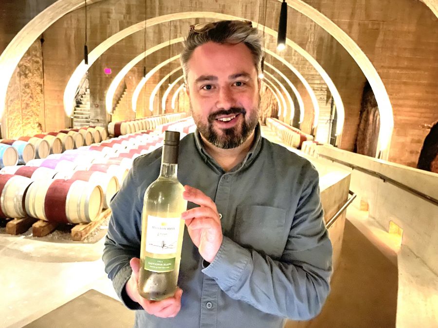 <who>Photo credits: Steve MacNaull/NowMedia Group</who>Winemaker Taylor Whelan shows off the Mission Hill 2024 Reserve Sauvignon Blanc ($26), blended at the West Kelowna winery of wines from New Zealand.