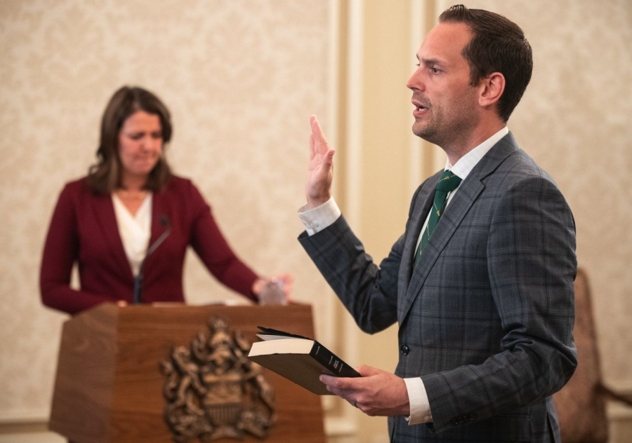 <who> Photo credit: Canadian Press </who> Alberta's government is introducing a new child-care funding formula in an effort to make $15-a-day the flat rate across province. Minister of Jobs, Economy and Trade Matt Jones is sworn into cabinet, in Edmonton, June 9, 2023.