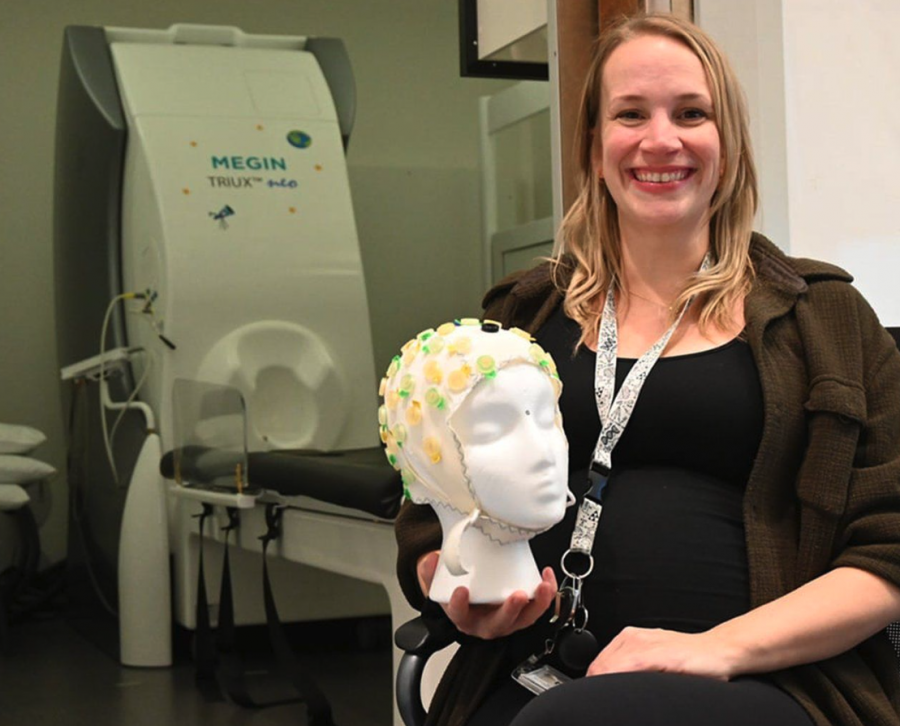 <who> Photo credit: Michelle Gamage, Local Journalism Initiative Reporter </who> The MEG reads electromagnetic fields to show researchers what area of the brain is activating, says SFU adjunct professor Maggie Clarke.