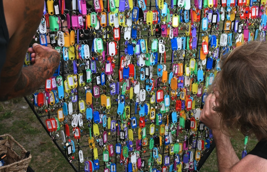 <who> Photo credit: Michelle Gamage/LJI </who> People were invited to add names of their friends and family to a memorial for local people who have died from toxic drug overdoses. One man wrote out 10 names before quietly adding them to the display.