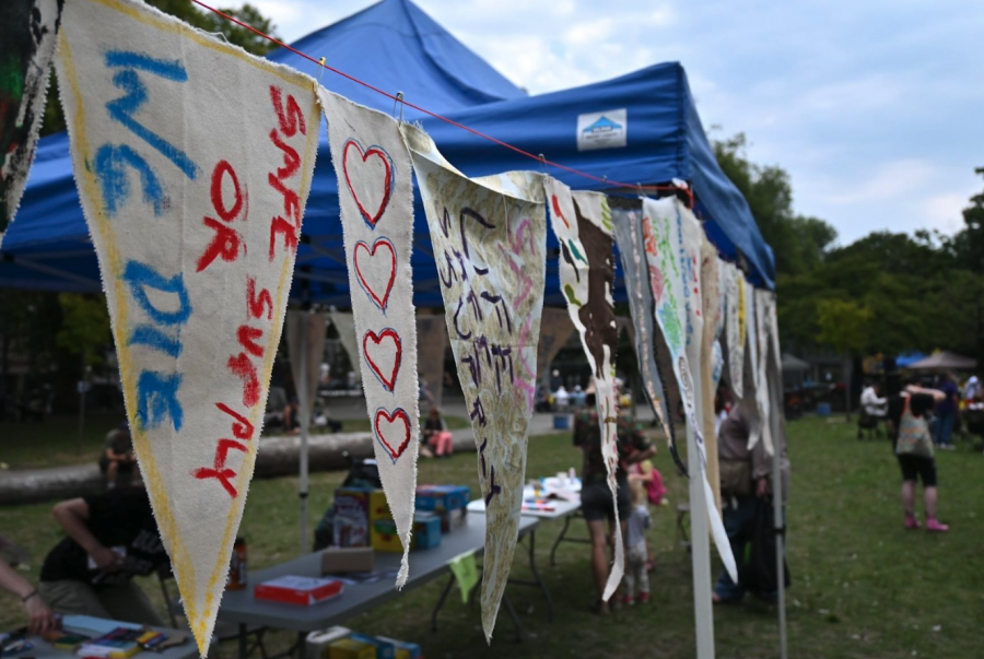 <who> Photo credit: Michelle Gamage/LJI </who> A banner at Sunday’s gathering. ‘Safe supply or we die’ is the rallying cry for advocates of a regulated drug supply they say will provide users an alternative to the risk of overdosing on toxic drugs via underground suppliers.
