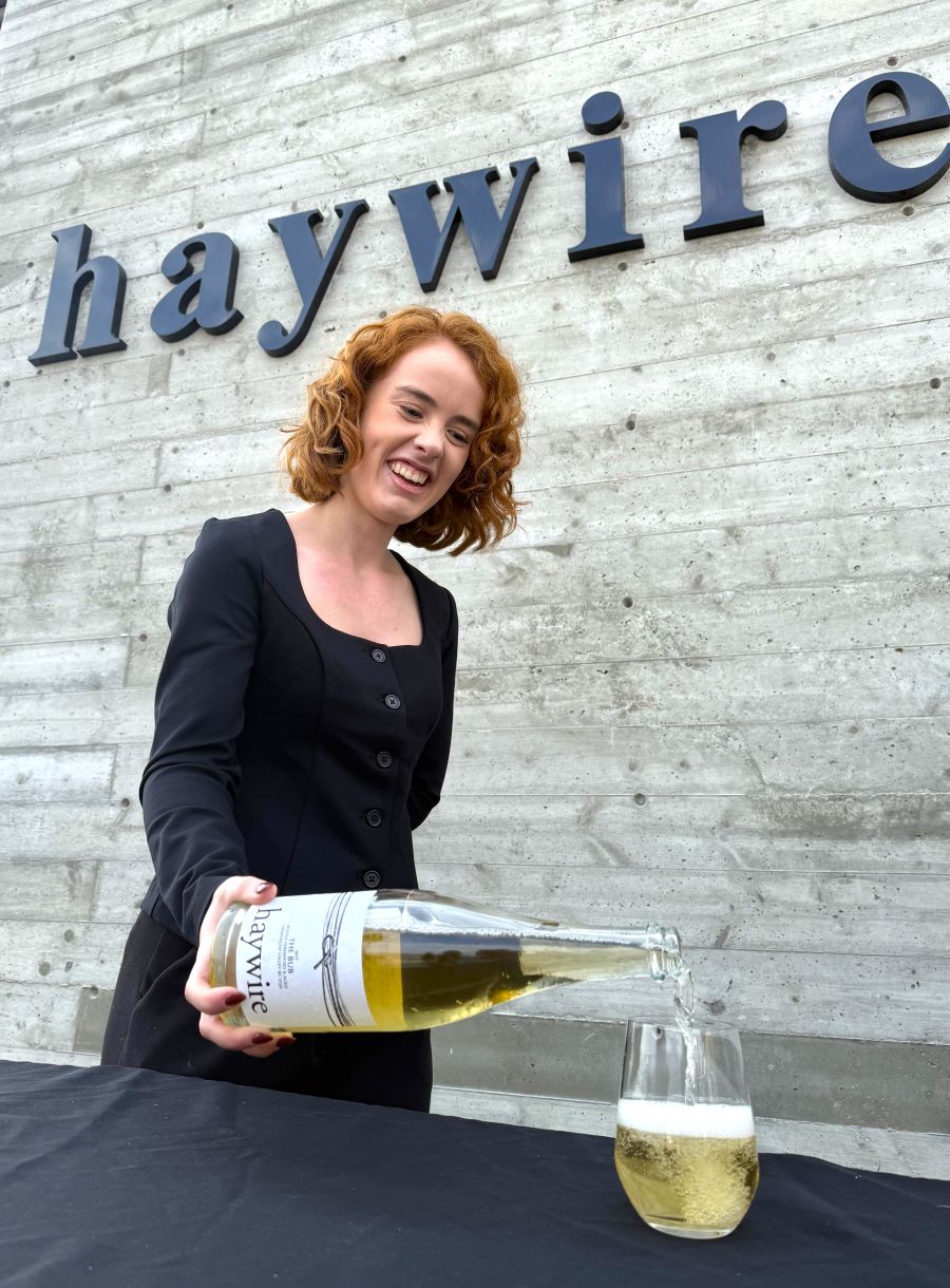 <who>Photo credit: Steve MacNaull/NowMedia Group</who>Marketing coordinator Katie Van der Gulik pours the 2017 The Bub at Haywire Winery's 15th anniversary party.