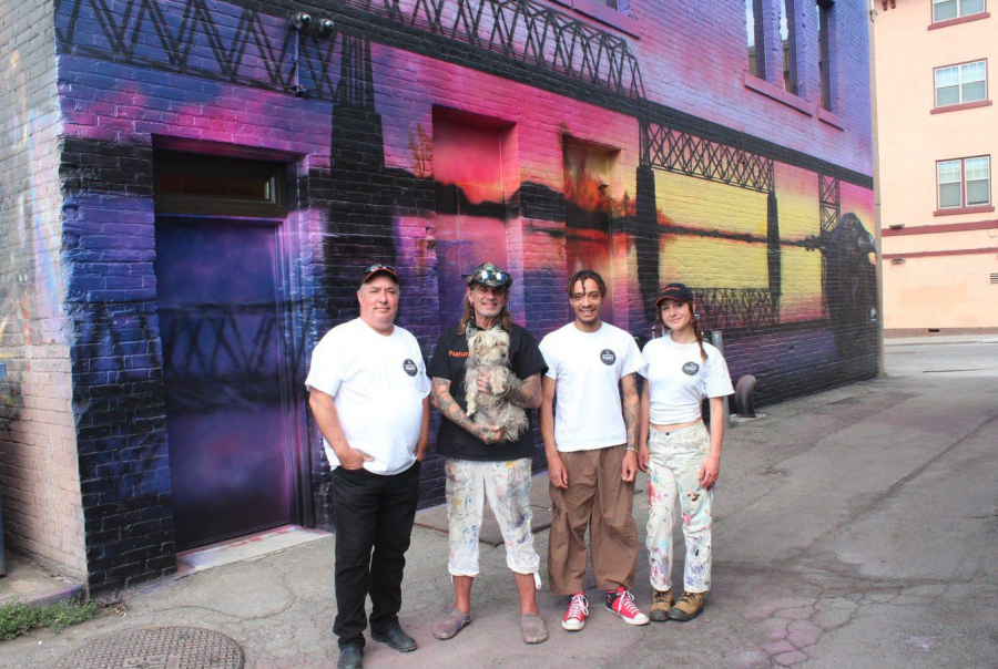 <who> Photo credit: Breanne Massey </who> From left to right: Vaughn Warren and his mentor, Paul Archer, took two young artists, Rowan Hunt and Jayde Richter from Old Federal Studios, under their wings to deliver a mural that honours the lost structure.
