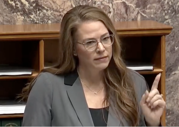 <who> Photo credit: BC Legislature </who> Renee Merrifield at work in the BC Legislative Assembly. She has accused the BC Conservatives of not putting enough time into debates.